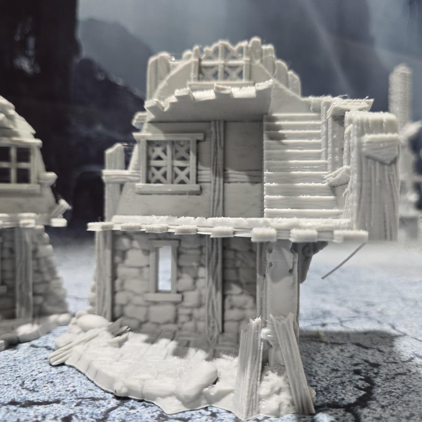 The Barrenfall Manor Ruins model features detailed remains of a medieval manor, complete with collapsed staircases, crumbling stone walls, and debris-filled rooms, perfect for creating an immersive, desolate atmosphere on your tabletop.