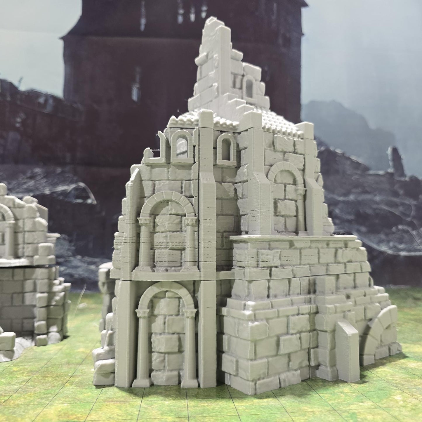 Explore the Arkenfel Barracks Building Ruin, featuring a medieval fortress design with detailed crumbling walls and strategic interior spaces, perfect for historical or fantasy tabletop games.
