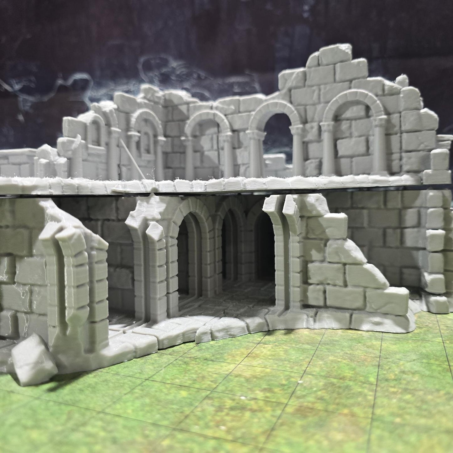 Explore the Arkenfel Barracks Building Ruin, featuring a medieval fortress design with detailed crumbling walls and strategic interior spaces, perfect for historical or fantasy tabletop games.