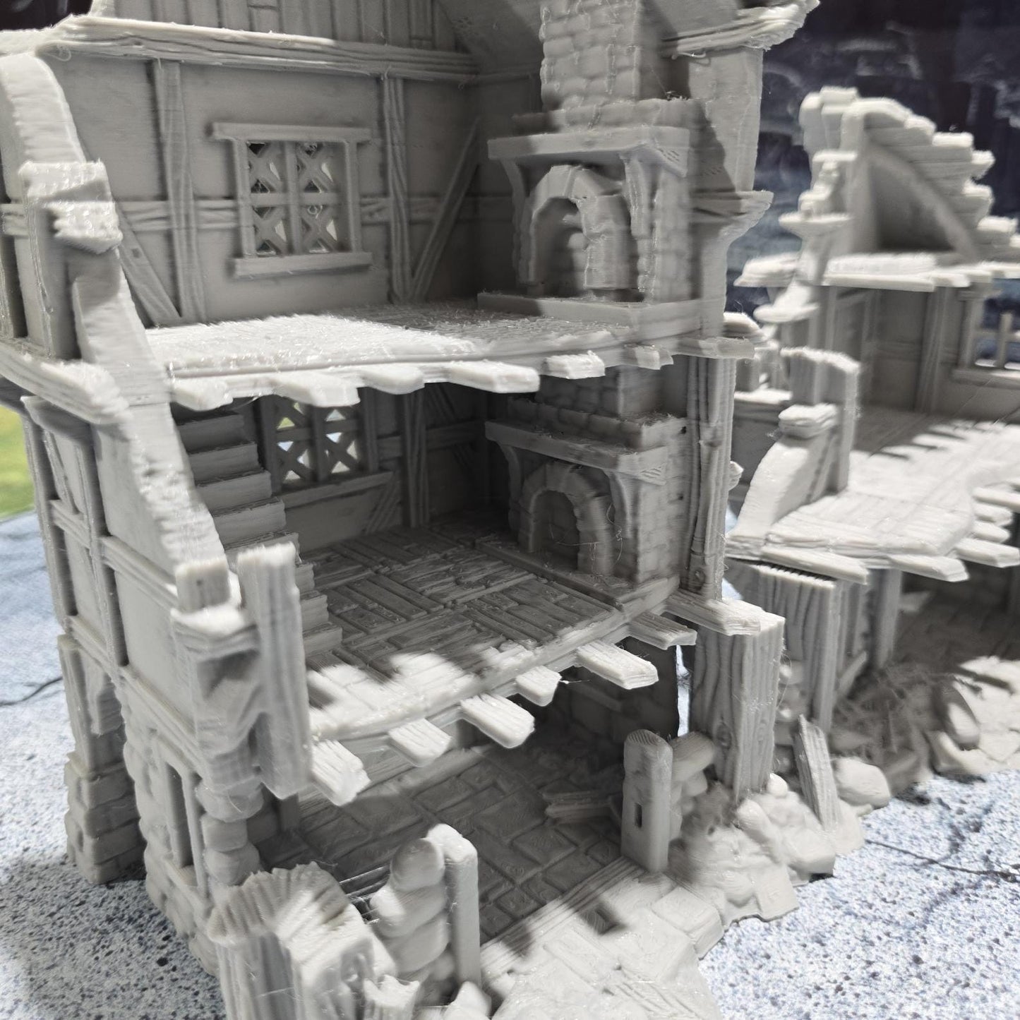 The Barrenfall Manor Ruins model features detailed remains of a medieval manor, complete with collapsed staircases, crumbling stone walls, and debris-filled rooms, perfect for creating an immersive, desolate atmosphere on your tabletop.