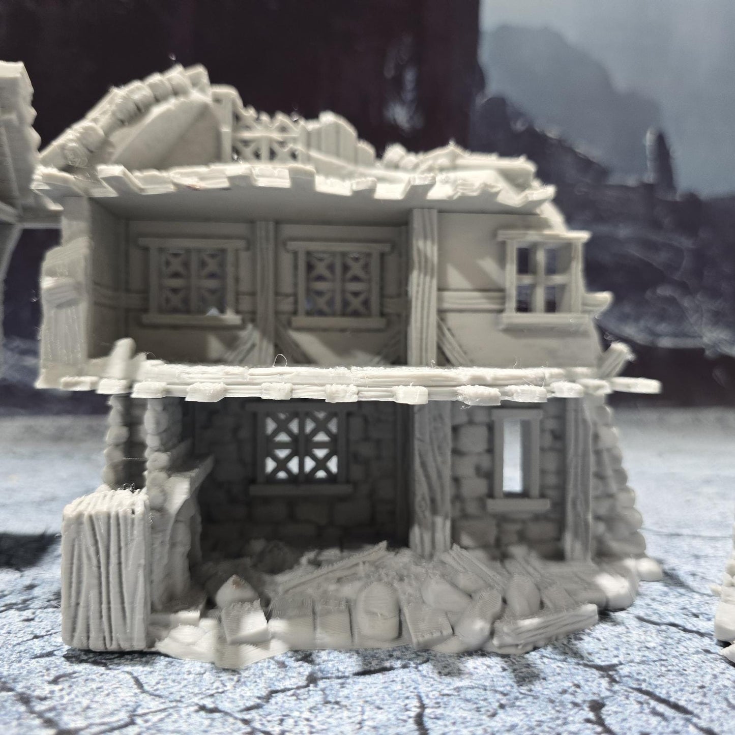 The Barrenfall Manor Ruins model features detailed remains of a medieval manor, complete with collapsed staircases, crumbling stone walls, and debris-filled rooms, perfect for creating an immersive, desolate atmosphere on your tabletop.