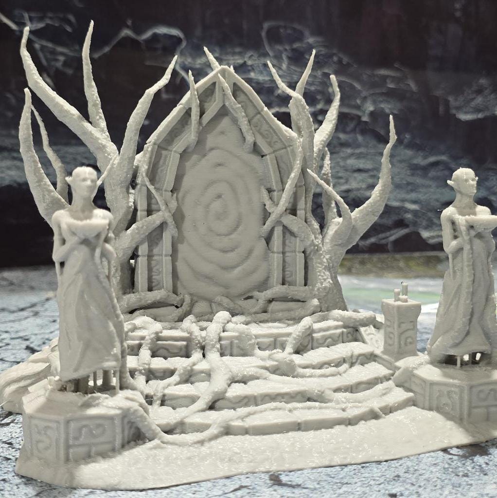 The Elven Portal model features a detailed fantasy gateway flanked by two statues, with intricate root and branch designs, perfect for enhancing fantasy tabletop settings.