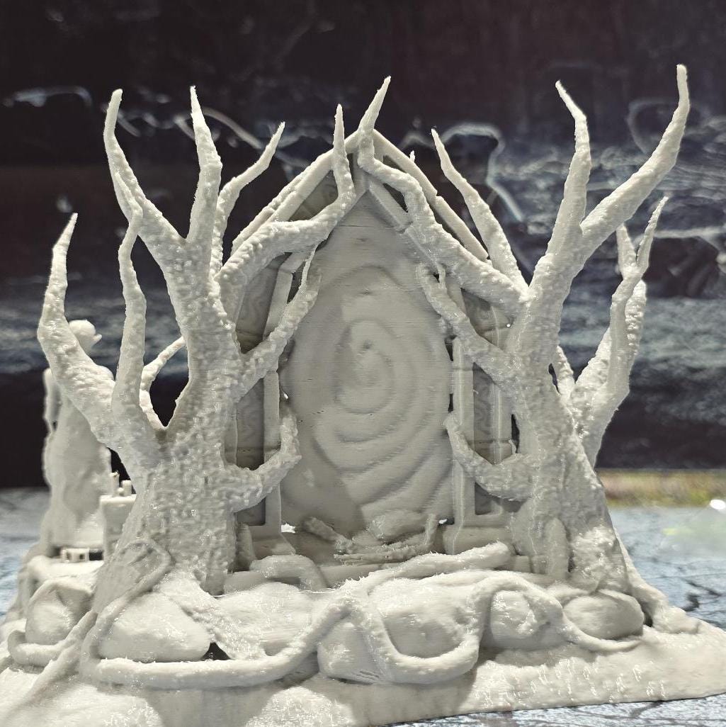 The Elven Portal model features a detailed fantasy gateway flanked by two statues, with intricate root and branch designs, perfect for enhancing fantasy tabletop settings.