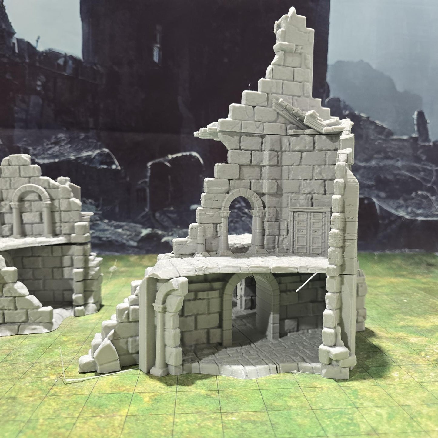 Explore the Arkenfel Barracks Building Ruin, featuring a medieval fortress design with detailed crumbling walls and strategic interior spaces, perfect for historical or fantasy tabletop games.