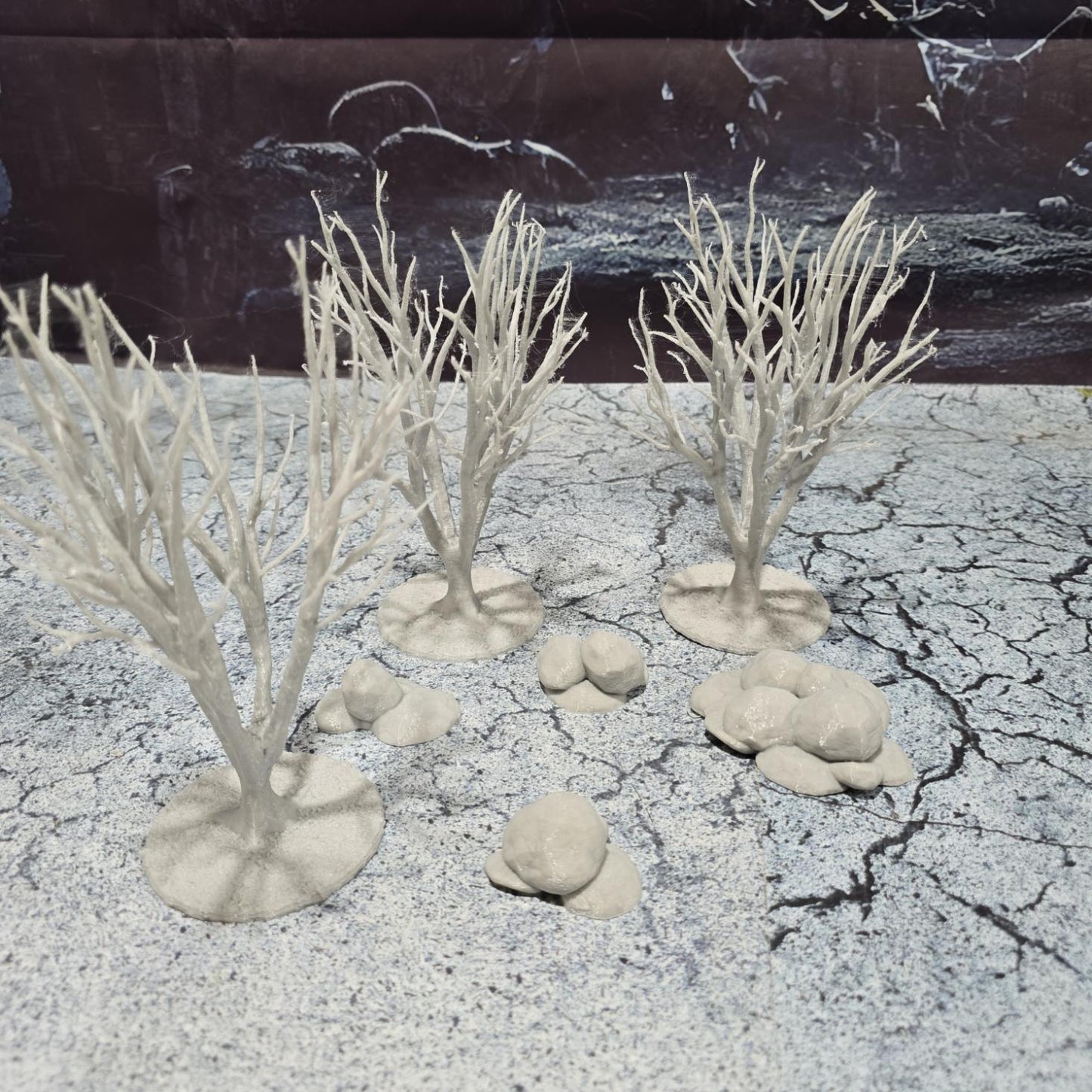 A set of 3 bare trees, each featuring intricate branches and a stable base. Perfect for creating desolate or haunted landscapes in tabletop RPGs and dioramas. Ideal for use in wintery or eerie settings.
