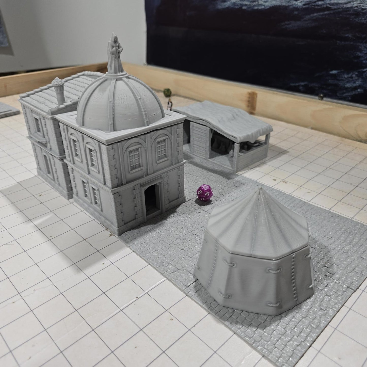 Complete medieval street set with two detailed buildings, a market tent and stall, and five cobblestone roads, perfect for tabletop role-playing games.