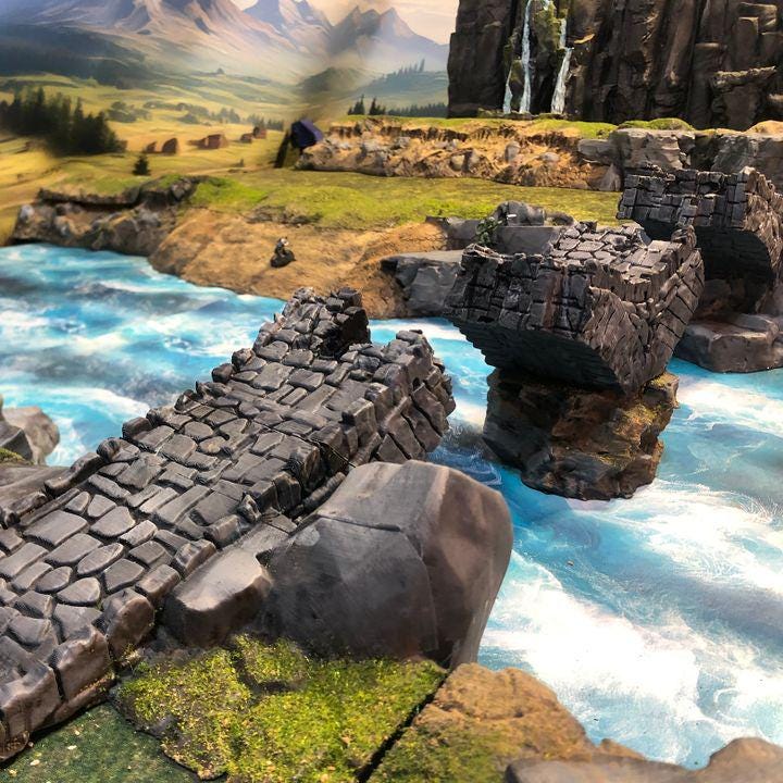 Detailed model of a damaged medieval stone bridge, showcasing weathered stones and structural decay, perfect for enhancing fantasy and historical tabletop games.