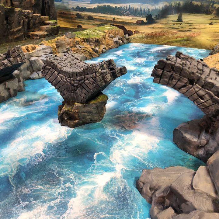 Detailed model of a damaged medieval stone bridge, showcasing weathered stones and structural decay, perfect for enhancing fantasy and historical tabletop games.