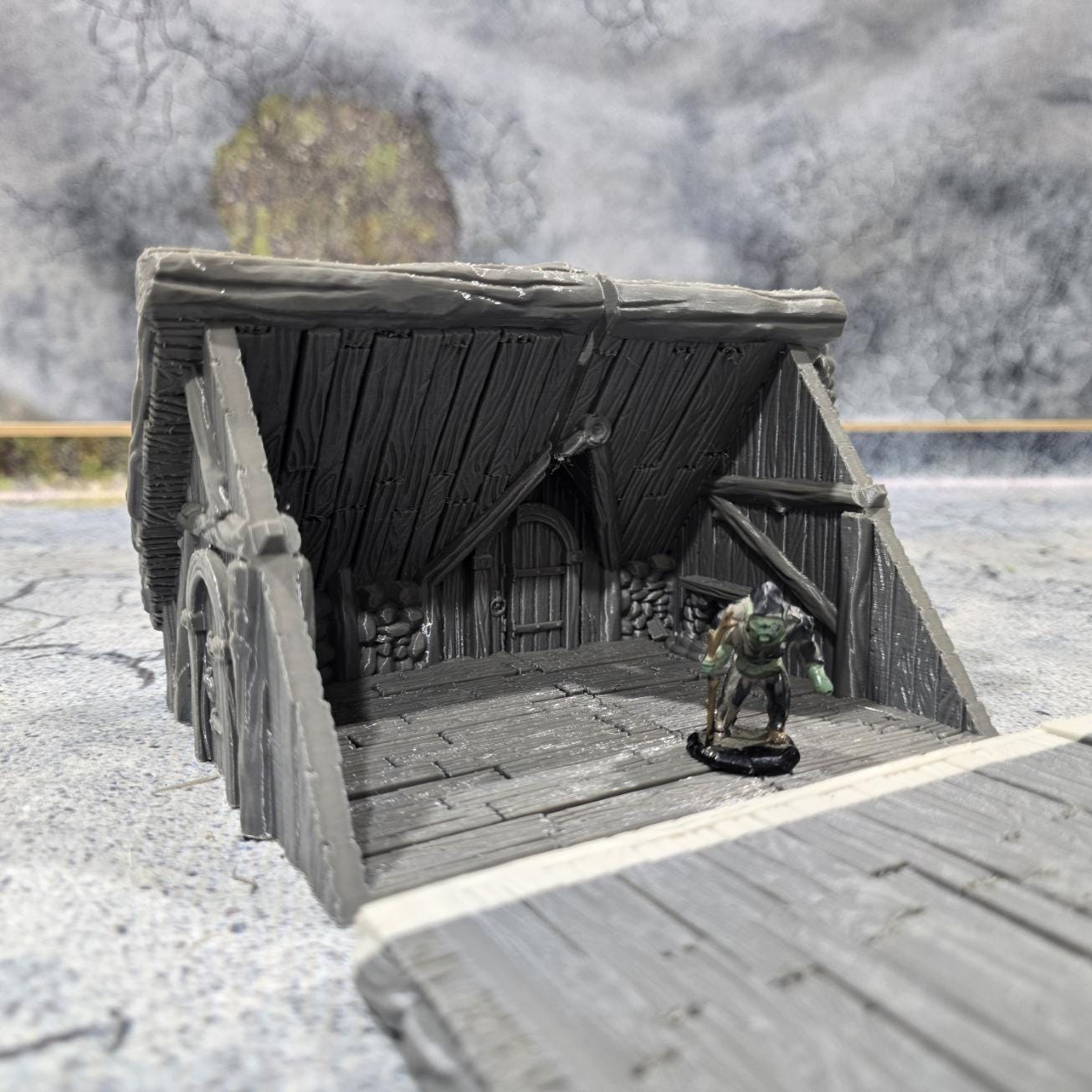 "Explore the life of a Viking with this accurately modeled Common House, featuring a detailed interior and rugged exterior, perfect for historical tabletop games."