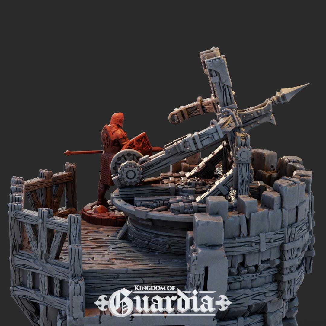 A towering medieval stone fortress with timber reinforcements rises from the battlefield. At its crest, a massive rotating ballista waits, manned by defenders ready to rain destruction on the enemy. The 5"x5" base and 6" height create a commanding presence on the tabletop, while the playable interior and battlements invite daring assaults and heroic last stands.