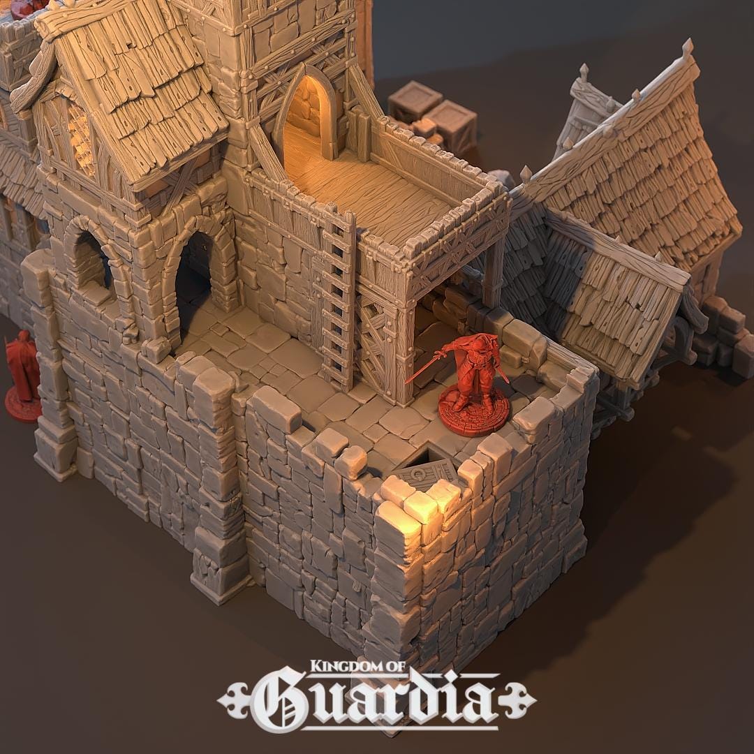 The Archery School – The Butts Compound rises with fortified stone walls, timber bridges, and training yards. The courtyard features archery targets, while towers and walkways provide elevated positions. Lit interiors and removable roofs make it fully playable, perfect for training encounters or dramatic battles.