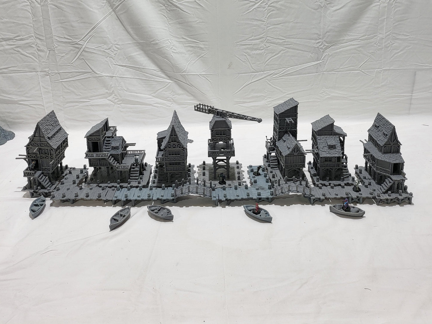 Detailed 28mm Old Lake Town set for tabletop RPGs, featuring six unique buildings with varied architectural styles. Perfect for creating immersive lakeside town scenes in games like D&D and Pathfinder.