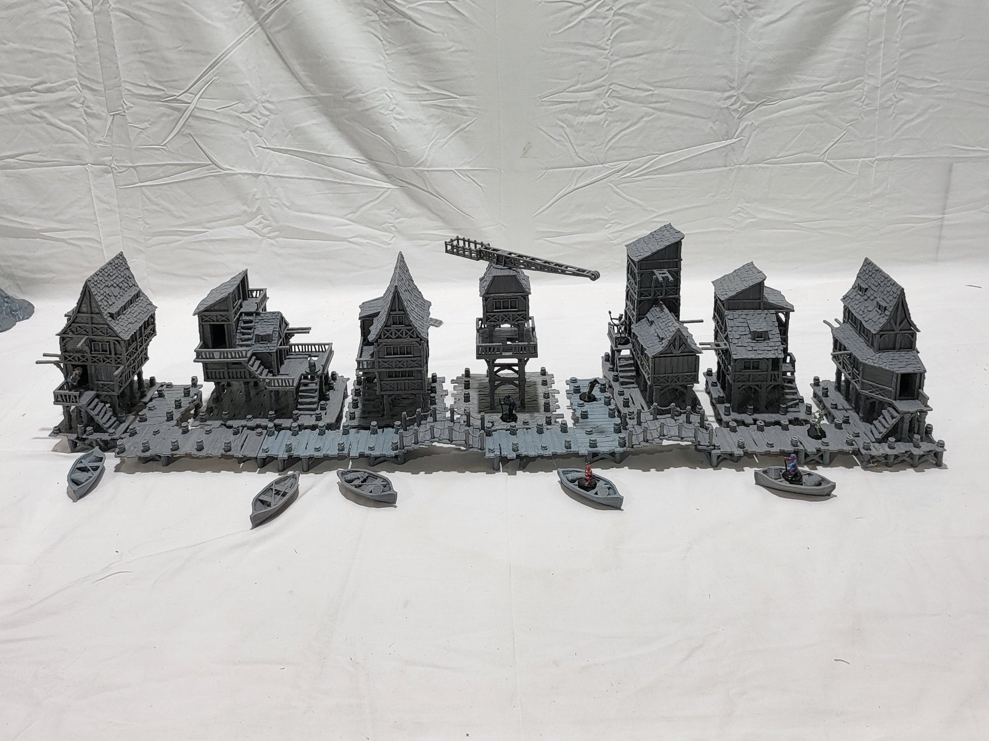 Detailed 28mm Old Lake Town set for tabletop RPGs, featuring six unique buildings with varied architectural styles. Perfect for creating immersive lakeside town scenes in games like D&D and Pathfinder.