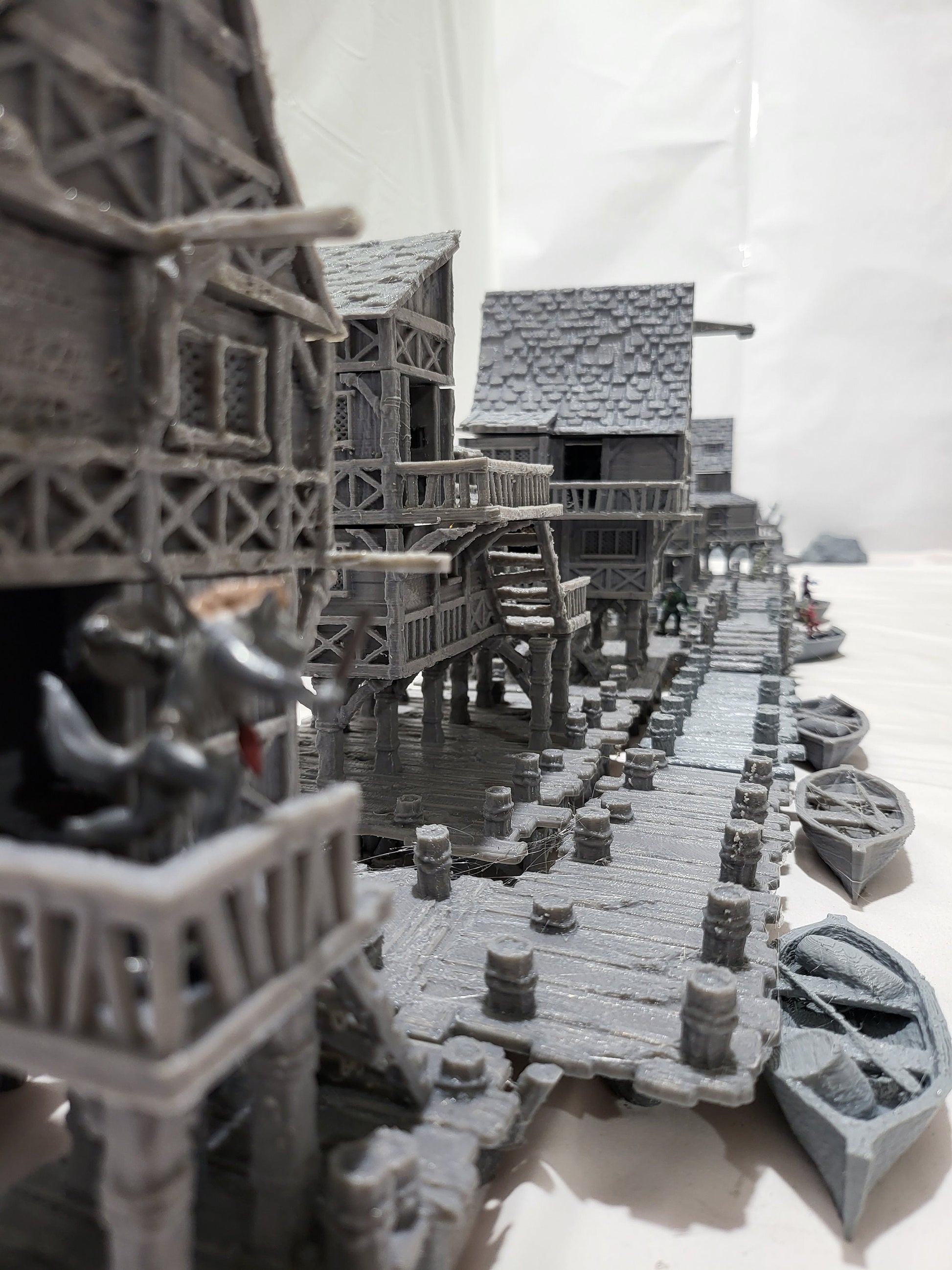 Detailed 28mm Old Lake Town set for tabletop RPGs, featuring six unique buildings with varied architectural styles. Perfect for creating immersive lakeside town scenes in games like D&D and Pathfinder.