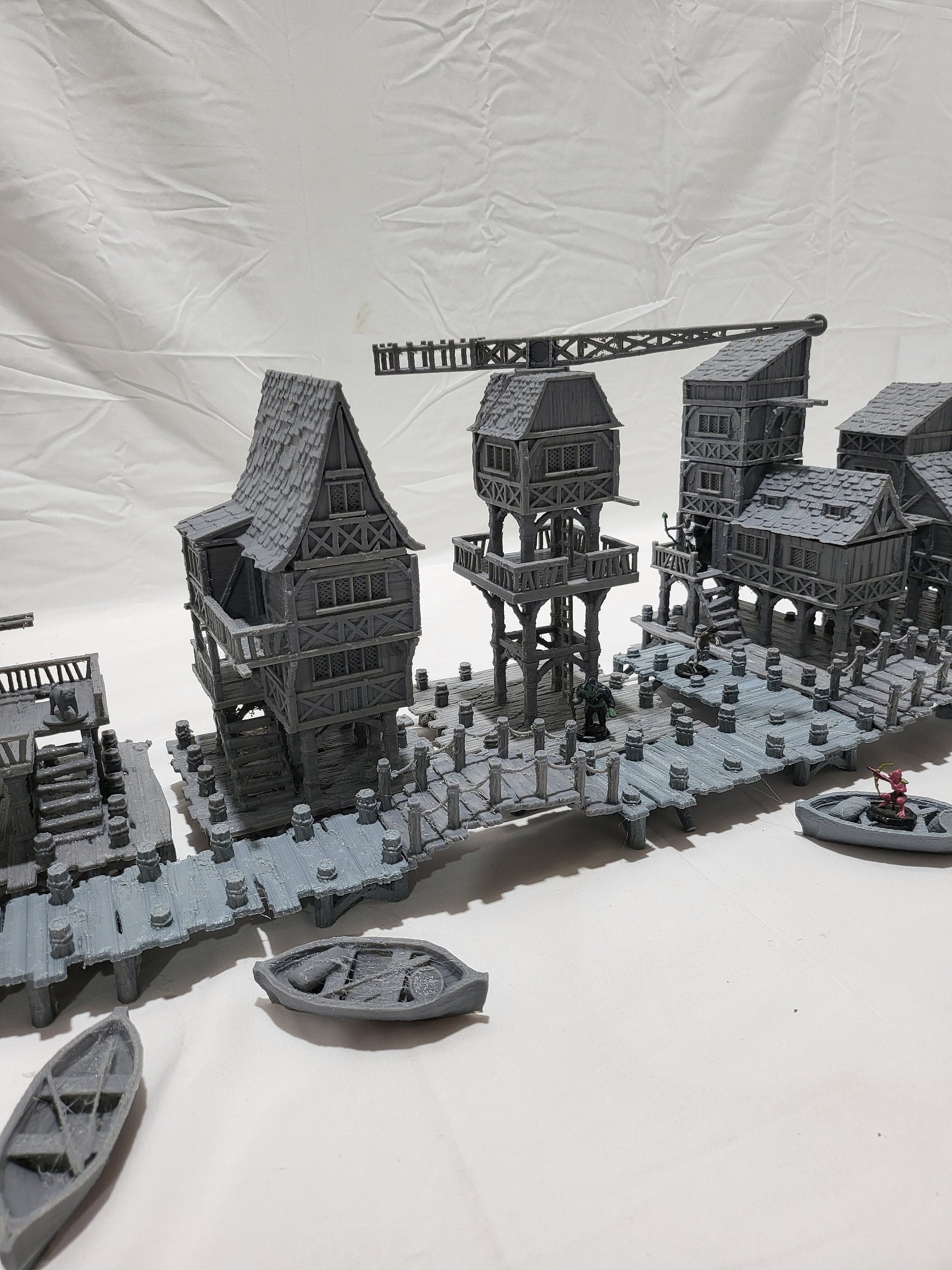 Detailed 28mm Old Lake Town set for tabletop RPGs, featuring six unique buildings with varied architectural styles. Perfect for creating immersive lakeside town scenes in games like D&D and Pathfinder.