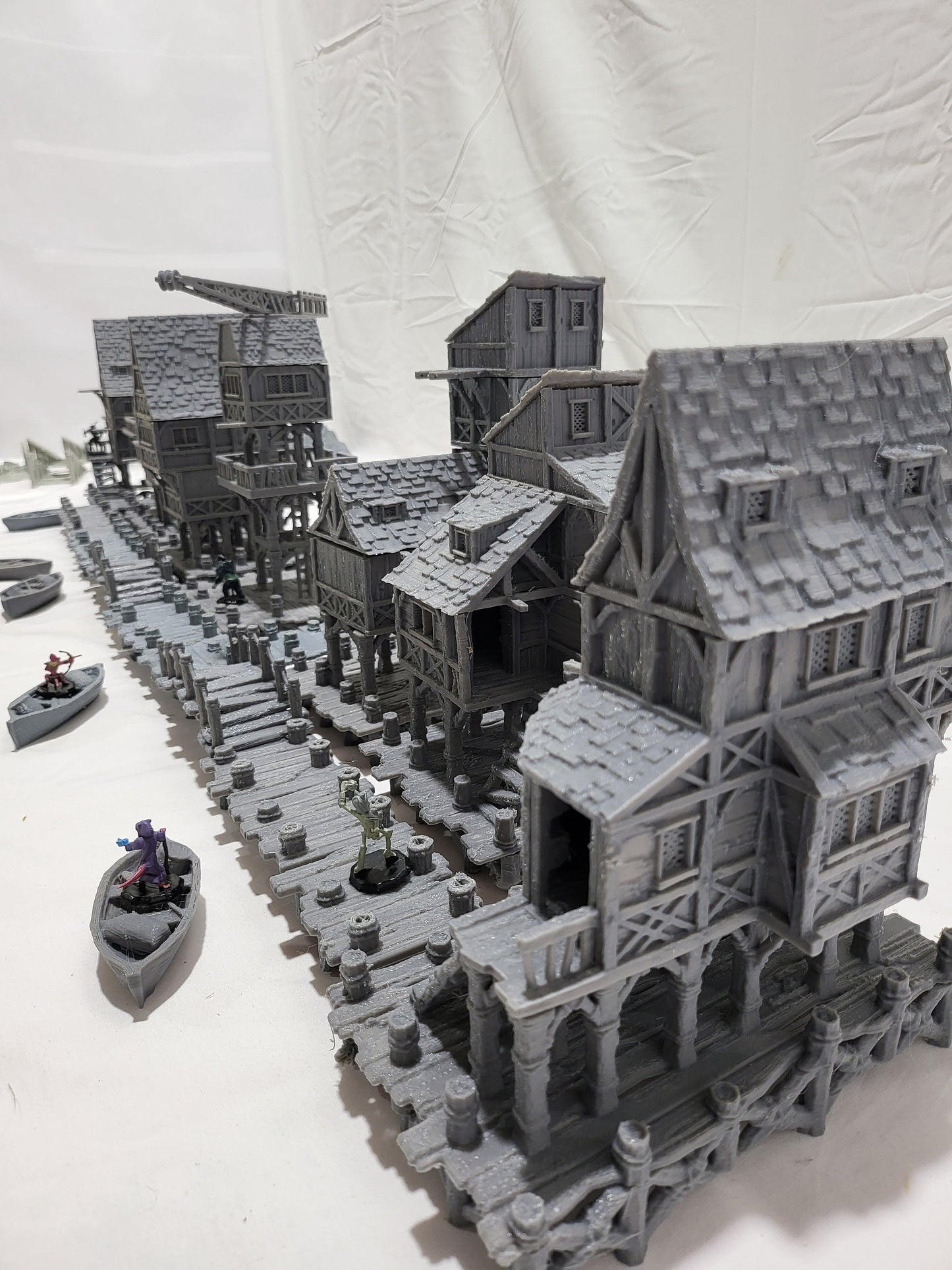 Detailed 28mm Old Lake Town set for tabletop RPGs, featuring six unique buildings with varied architectural styles. Perfect for creating immersive lakeside town scenes in games like D&D and Pathfinder.