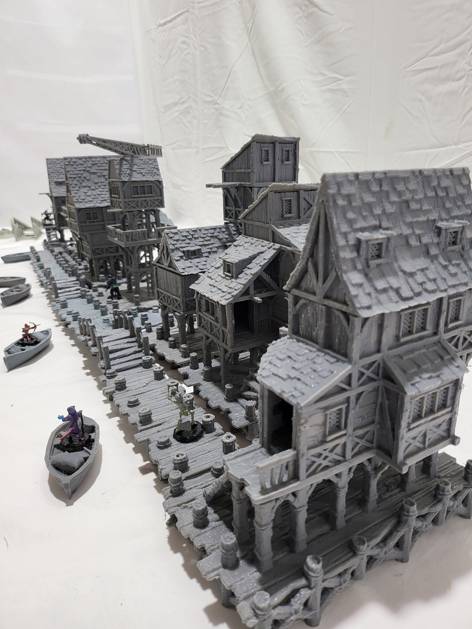 Detailed 28mm Old Lake Town set for tabletop RPGs, featuring six unique buildings with varied architectural styles. Perfect for creating immersive lakeside town scenes in games like D&D and Pathfinder.