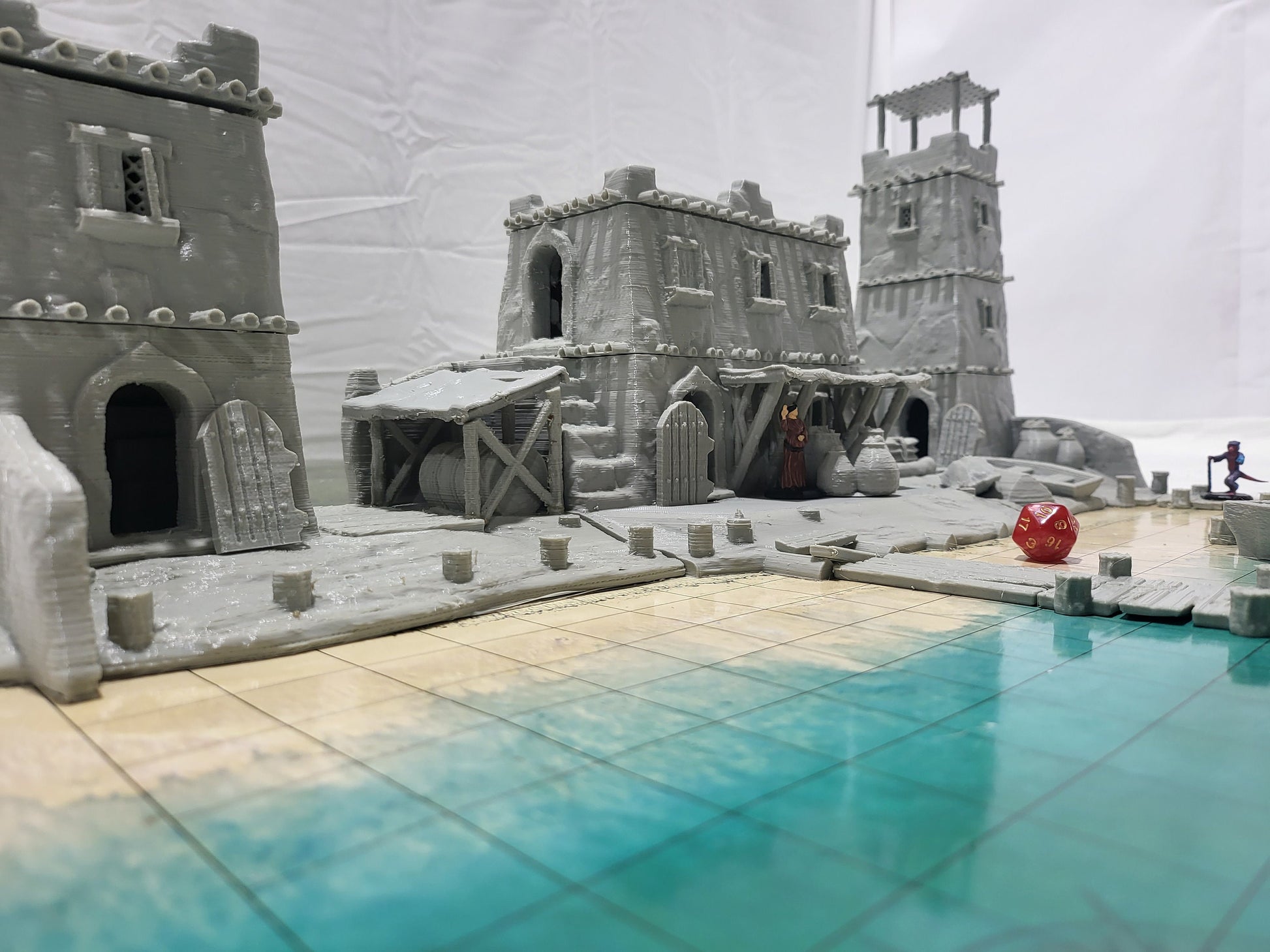 Detailed 28mm desert dock and port set for tabletop RPGs, featuring various buildings and dock structures with intricate designs. Perfect for creating immersive port scenes in games like D&D and Pathfinder.
