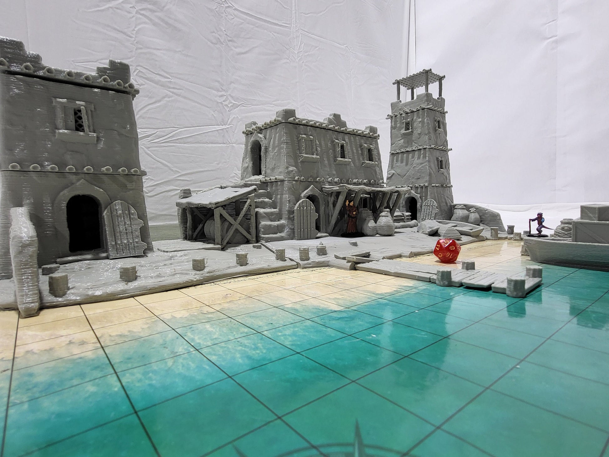 Detailed 28mm desert dock and port set for tabletop RPGs, featuring various buildings and dock structures with intricate designs. Perfect for creating immersive port scenes in games like D&D and Pathfinder.