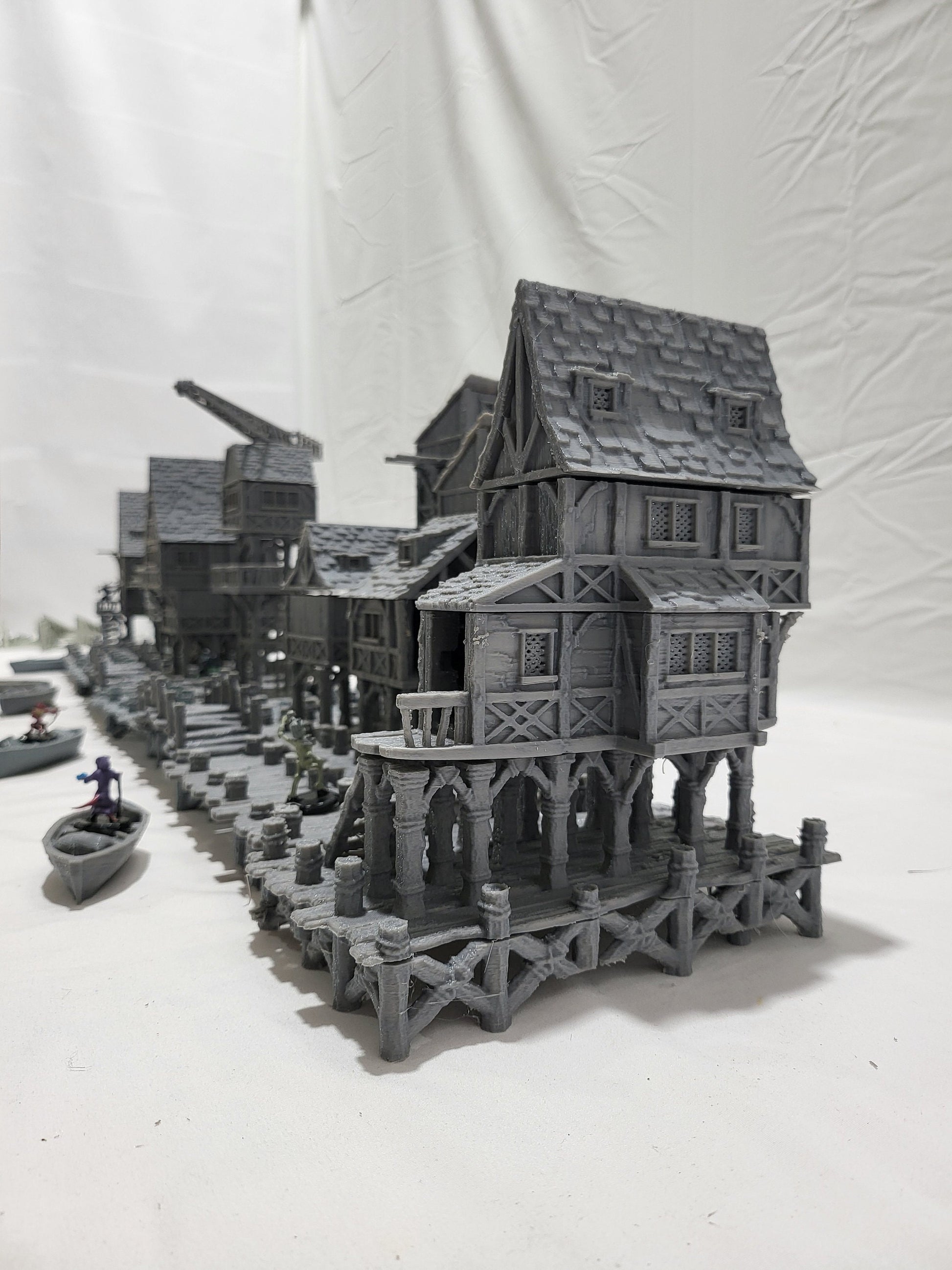 Detailed 28mm Old Lake Town set for tabletop RPGs, featuring six unique buildings with varied architectural styles. Perfect for creating immersive lakeside town scenes in games like D&D and Pathfinder.