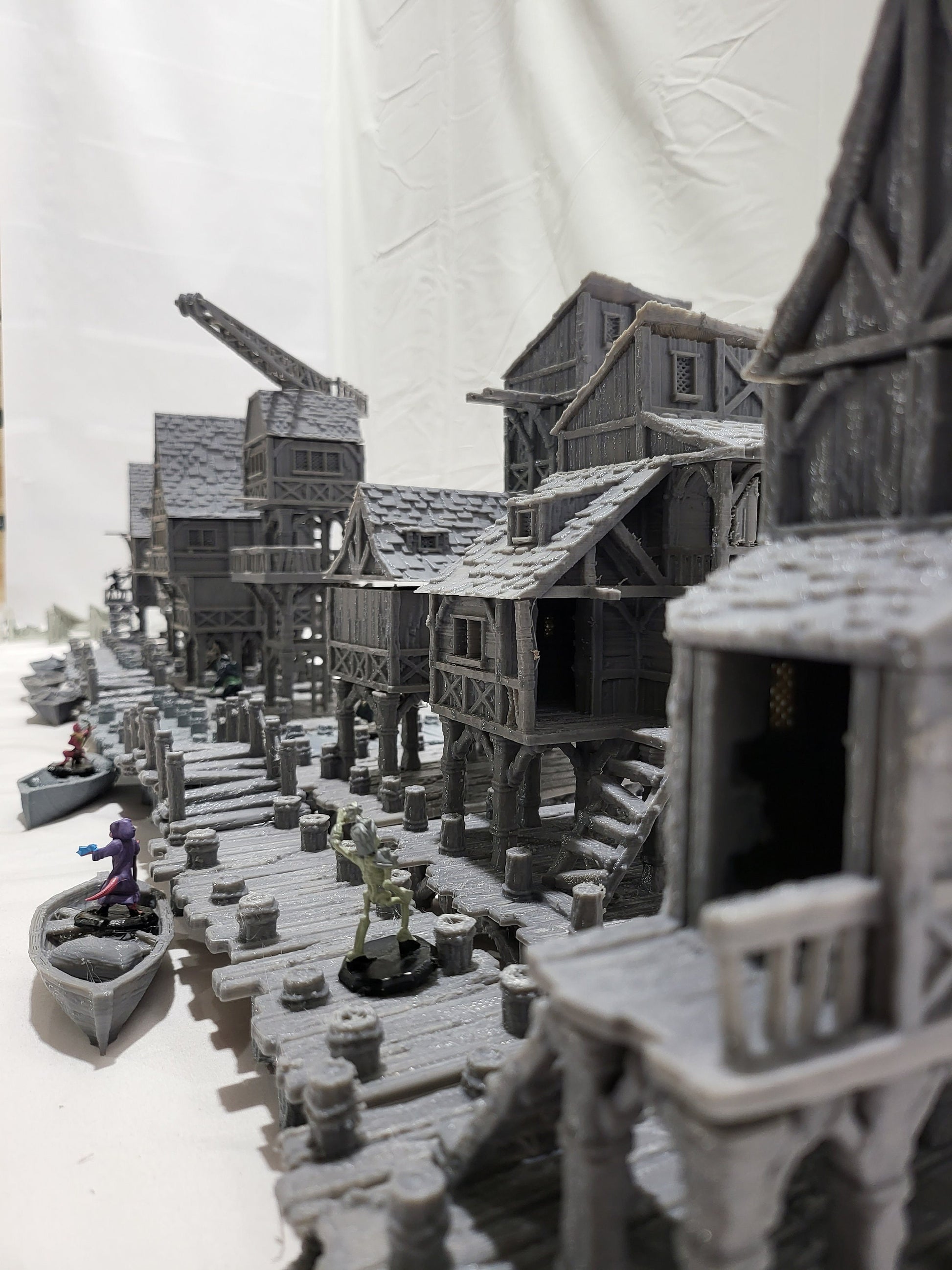 Detailed 28mm Old Lake Town set for tabletop RPGs, featuring six unique buildings with varied architectural styles. Perfect for creating immersive lakeside town scenes in games like D&D and Pathfinder.