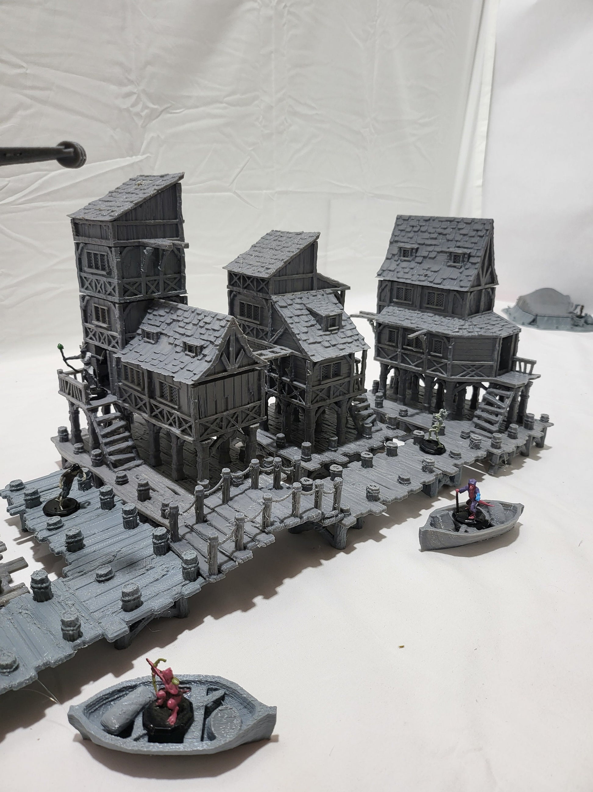 Detailed 28mm Old Lake Town set for tabletop RPGs, featuring six unique buildings with varied architectural styles. Perfect for creating immersive lakeside town scenes in games like D&D and Pathfinder.