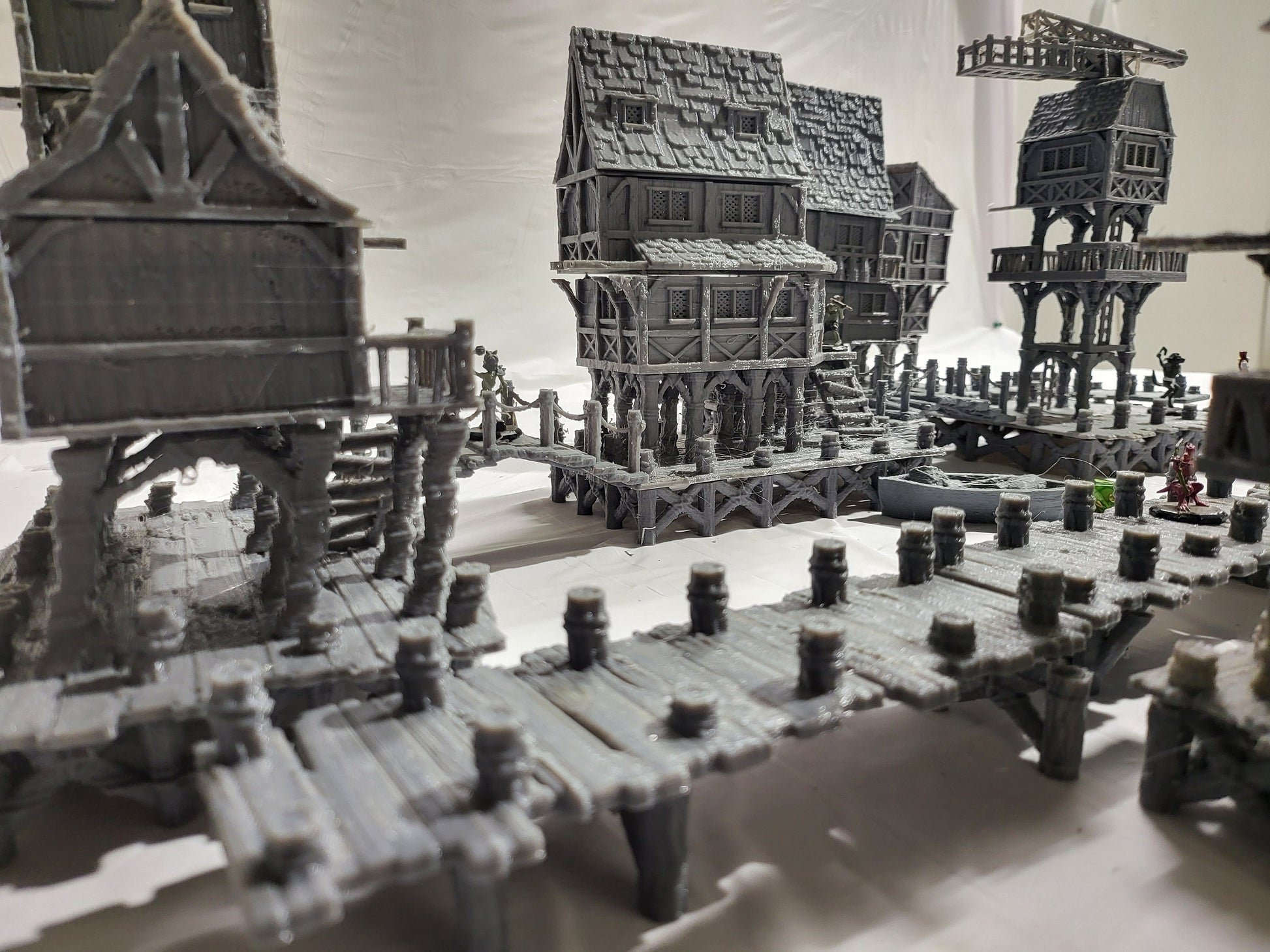 Detailed 28mm Old Lake Town set for tabletop RPGs, featuring six unique buildings with varied architectural styles. Perfect for creating immersive lakeside town scenes in games like D&D and Pathfinder.