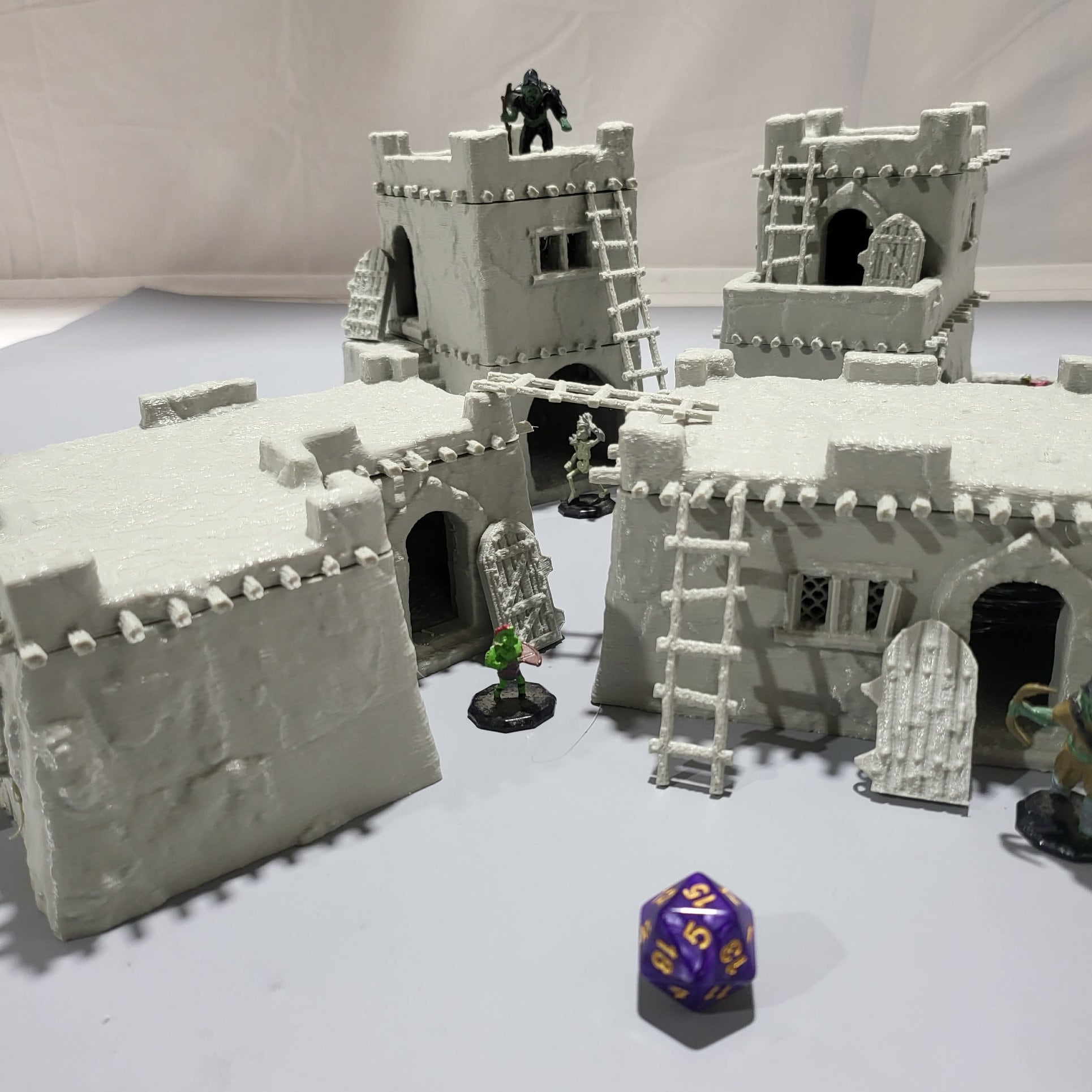 Detailed 28mm desert mud house set for tabletop RPGs, featuring various buildings and terrain pieces with intricate designs. Perfect for creating immersive desert village scenes in games like D&D and Pathfinder.