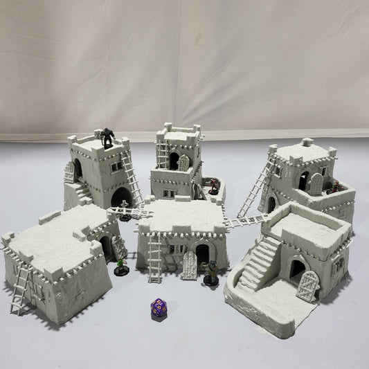 Detailed 28mm desert mud house set for tabletop RPGs, featuring various buildings and terrain pieces with intricate designs. Perfect for creating immersive desert village scenes in games like D&D and Pathfinder.