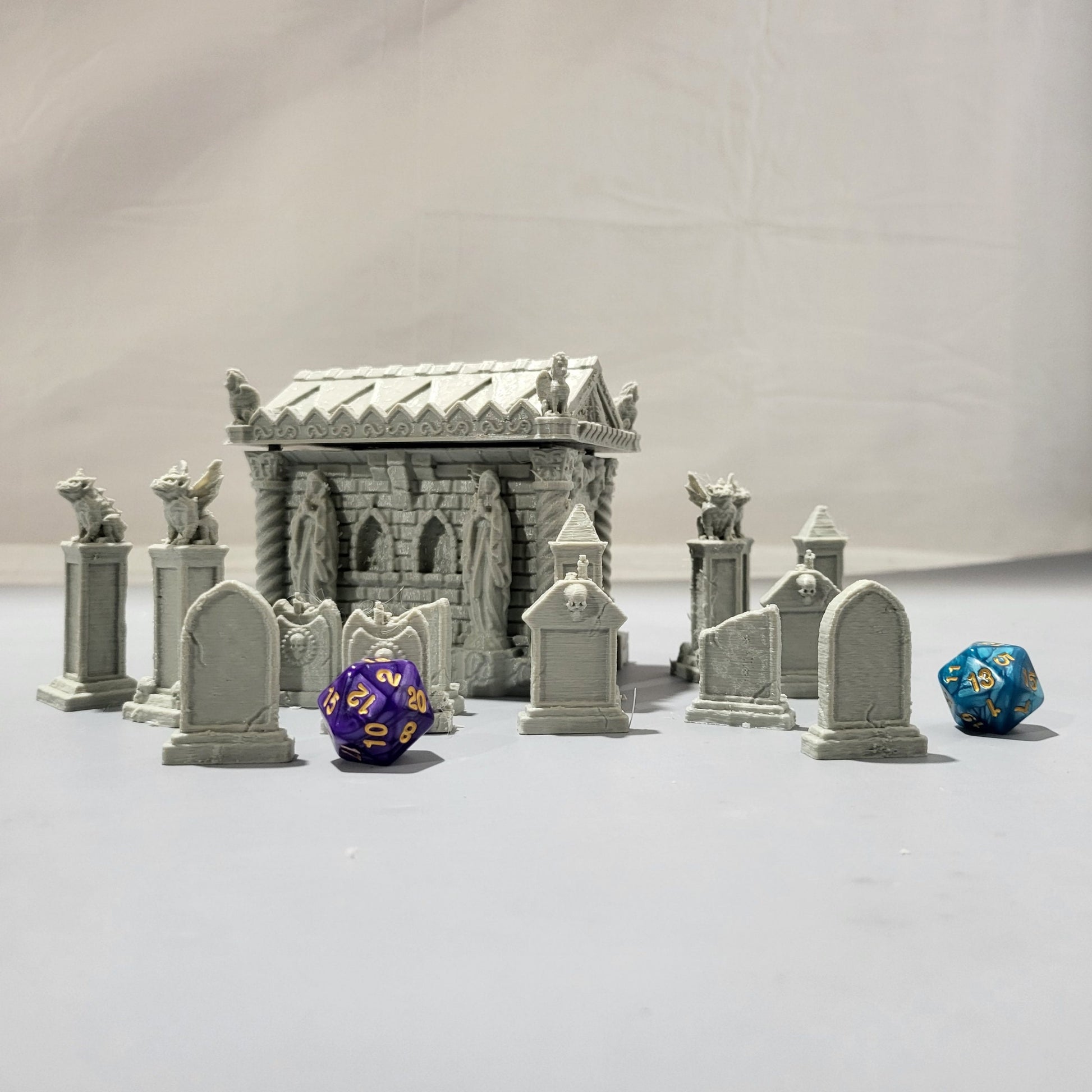 Detailed 15-piece cemetery set for tabletop RPGs, featuring a mausoleum and various gravestones. Perfect for creating eerie graveyard scenes in games like D&D, Pathfinder, and Warhammer.