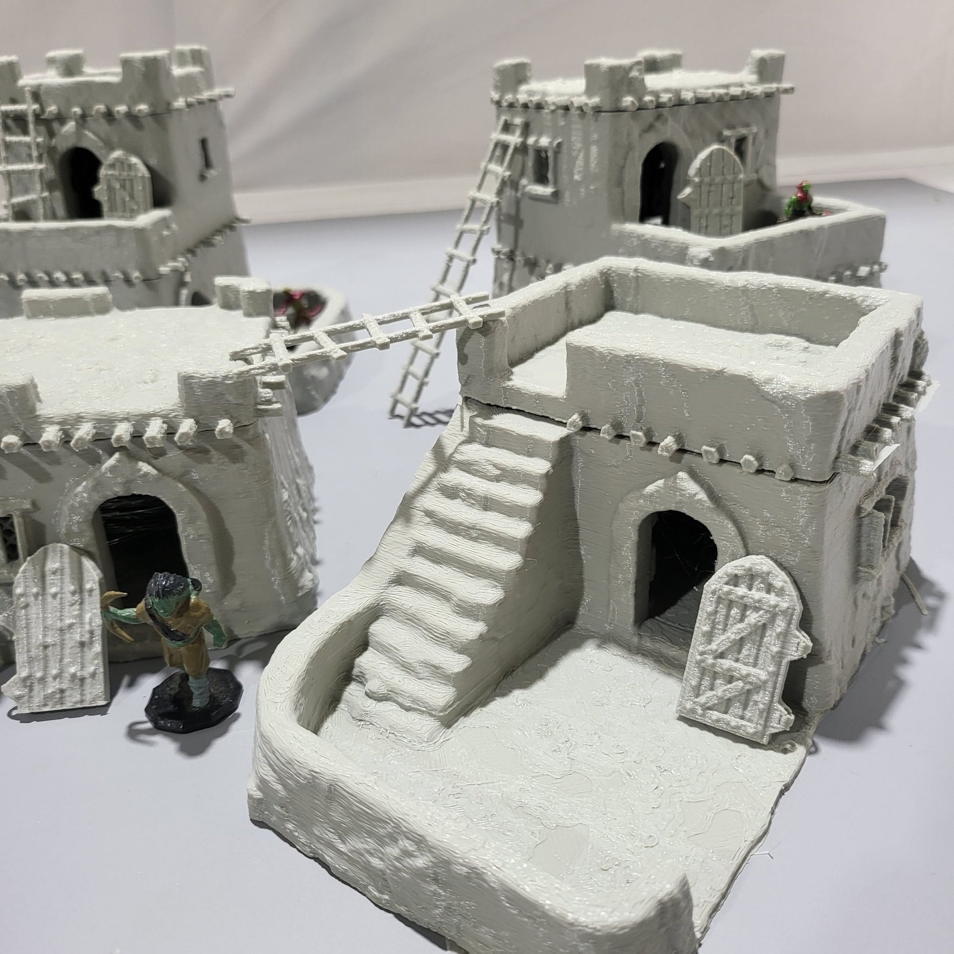 Detailed 28mm desert mud house set for tabletop RPGs, featuring various buildings and terrain pieces with intricate designs. Perfect for creating immersive desert village scenes in games like D&D and Pathfinder.