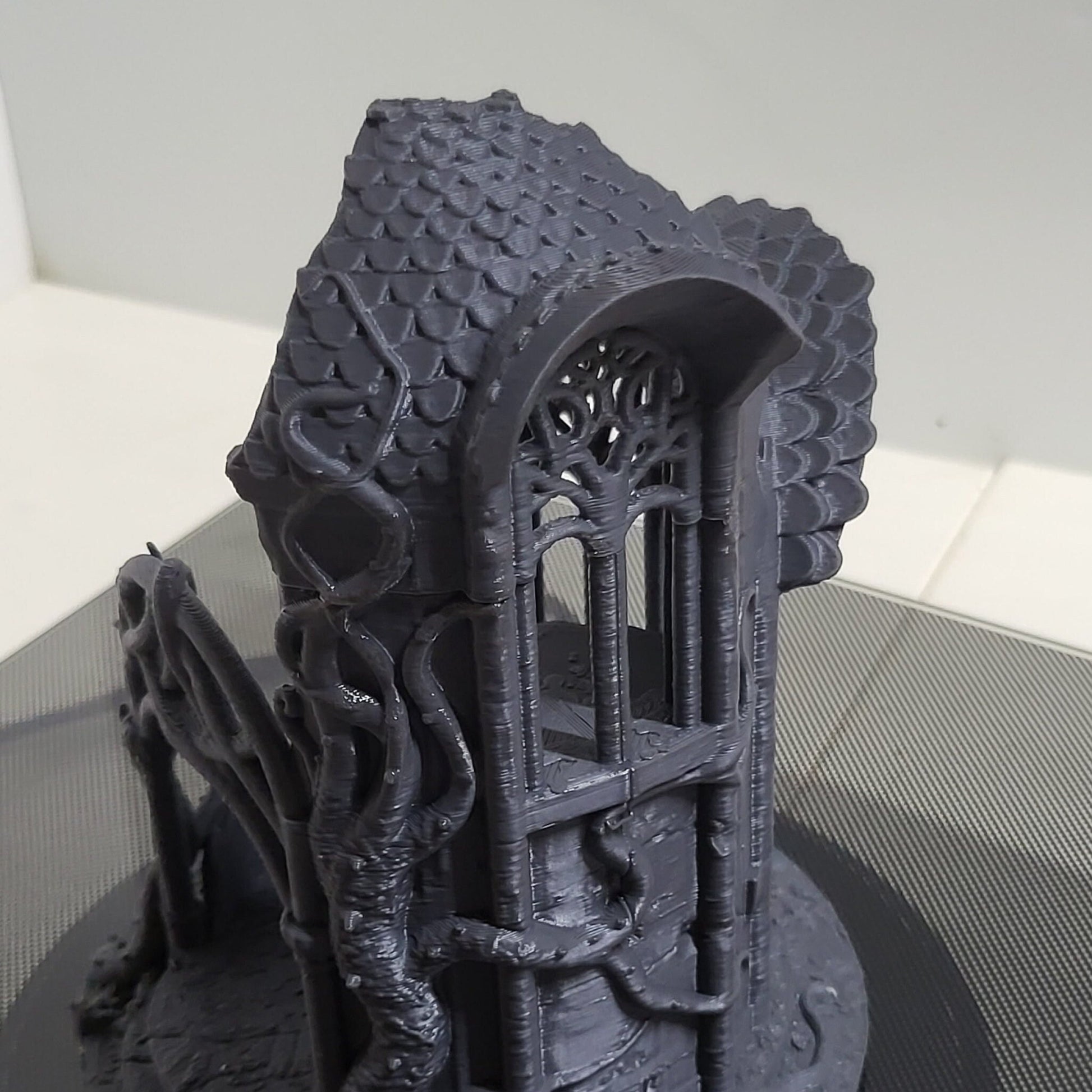 A detailed 3D-printed model of a ruined Elven watchtower for tabletop RPGs like DnD and Pathfinder. Features include intricate stone walls, elegant arches, and remnants of Elven craftsmanship. Perfect for fantasy and historical settings