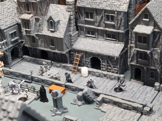 The first image showcases a top-down view of the entire modular town district set, displaying the layout and arrangement of the buildings and streets.