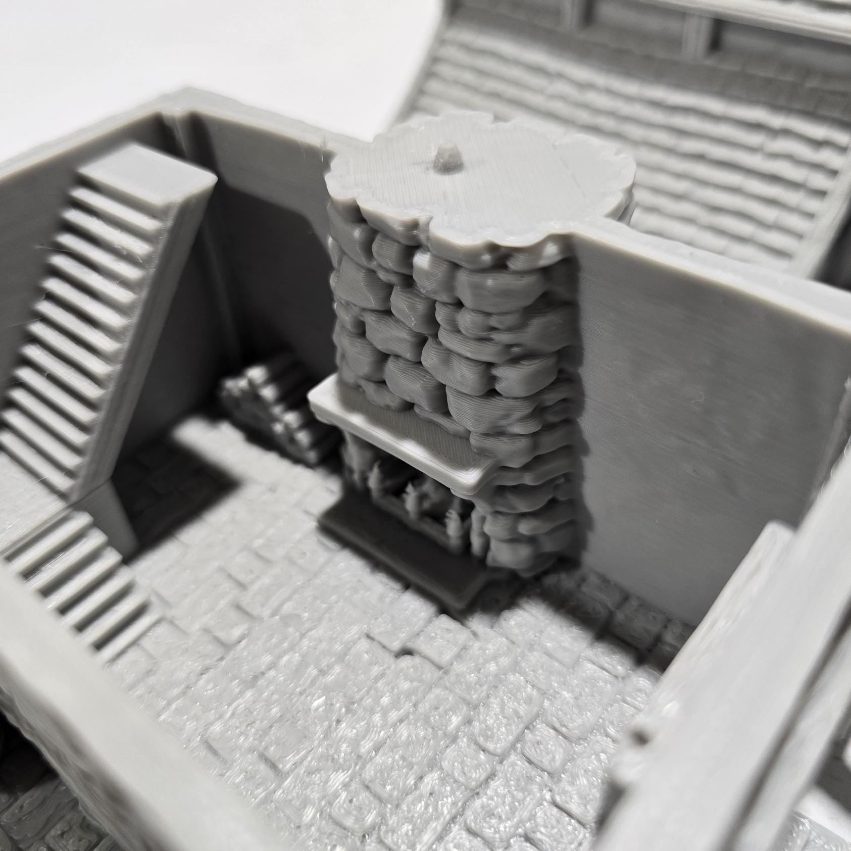 Briarwood House 5 model is a highly detailed medieval half-timbered house, showcasing a classic stone & timber structure. The design includes a steeply pitched roof, a stone chimney, & lattice windows, perfect for enhancing medieval tabletop games