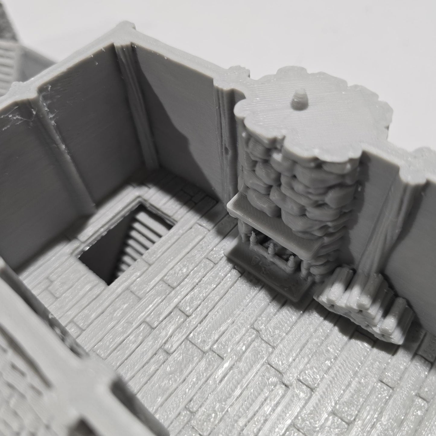 Briarwood House 5 model is a highly detailed medieval half-timbered house, showcasing a classic stone & timber structure. The design includes a steeply pitched roof, a stone chimney, & lattice windows, perfect for enhancing medieval tabletop games