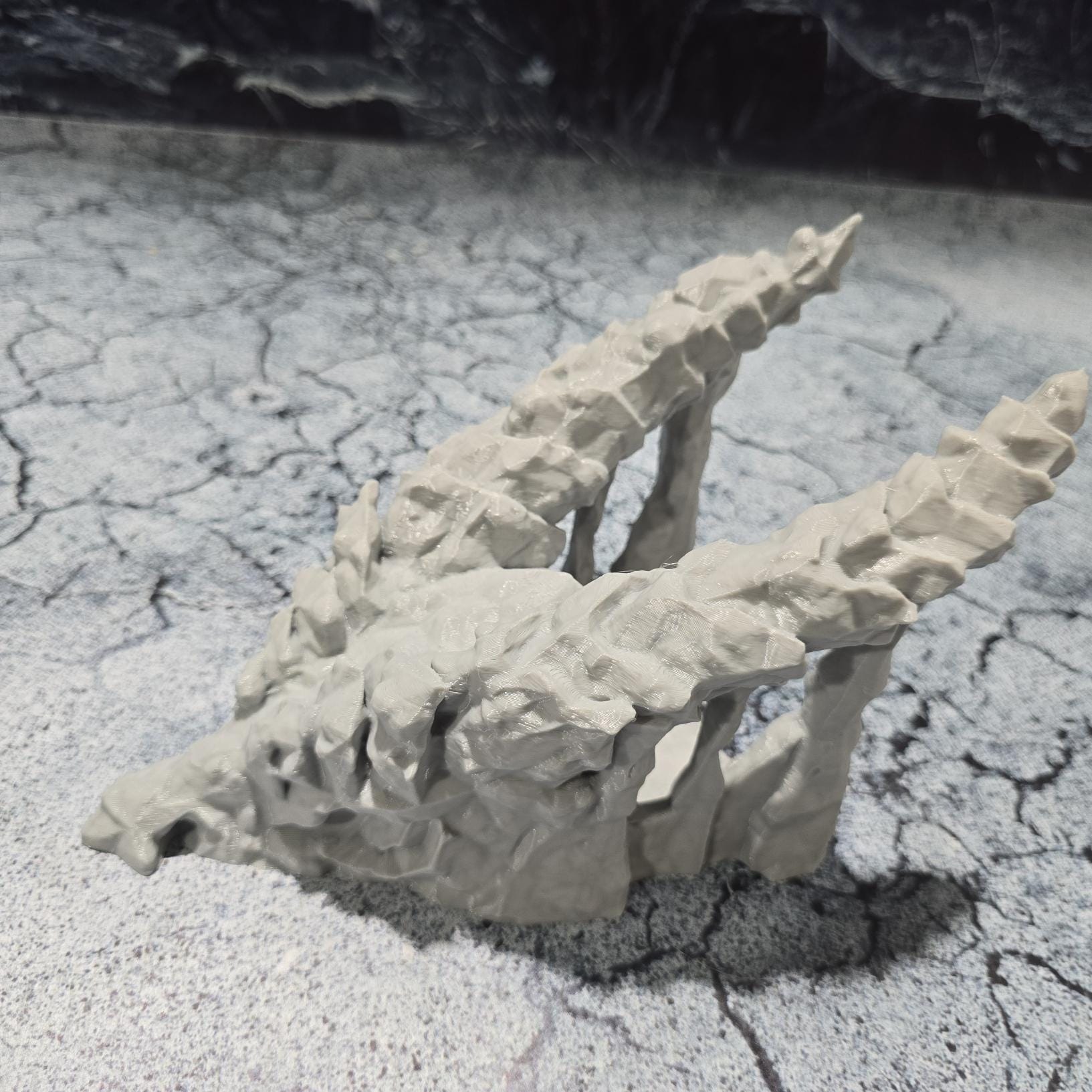 A meticulously crafted 3D model depicting a dragon's skull that serves as a cave entrance, set against a backdrop of ominous, dark castles and rugged terrains, perfect for enhancing medieval and fantasy-themed gaming sessions.