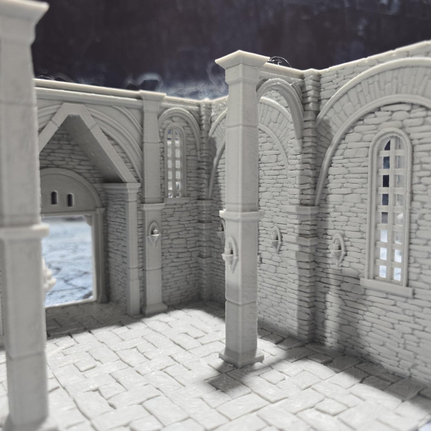 The Greendale Church of the Dale features a medieval gothic design with two angel statues and sets of pews, ideal for historical tabletop settings.
