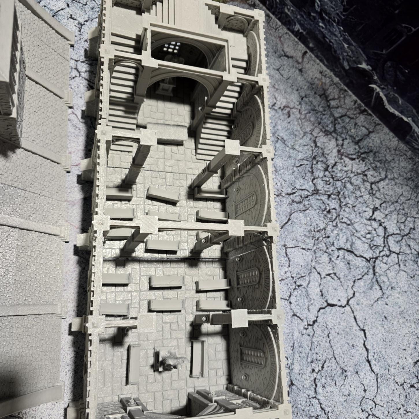 The Greendale Church of the Dale features a medieval gothic design with two angel statues and sets of pews, ideal for historical tabletop settings.