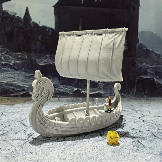 The Viking Invader Ship model features a detailed dragon-head prow, shield-lined sides, and a furled sail, capturing the essence of Norse seafaring prowess, perfect for bringing epic Viking adventures to life on your tabletop.