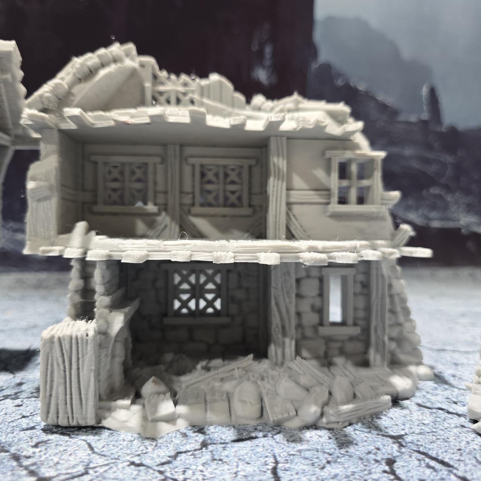 The Barrenfall Manor Ruins model features detailed remains of a medieval manor, complete with collapsed staircases, crumbling stone walls, and debris-filled rooms, perfect for creating an immersive, desolate atmosphere on your tabletop.