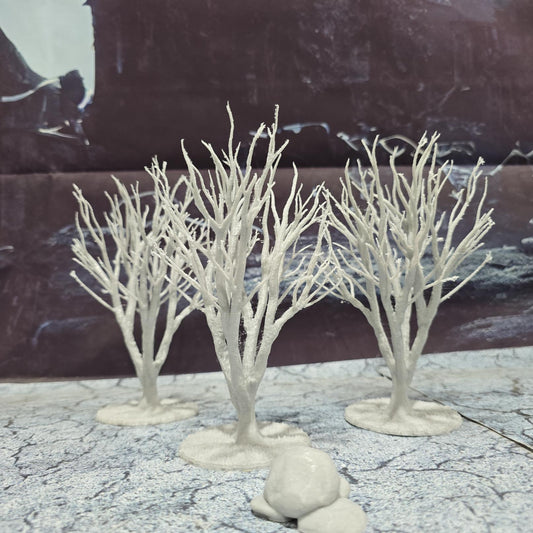 A set of 3 bare trees, each featuring intricate branches and a stable base. Perfect for creating desolate or haunted landscapes in tabletop RPGs and dioramas. Ideal for use in wintery or eerie settings.