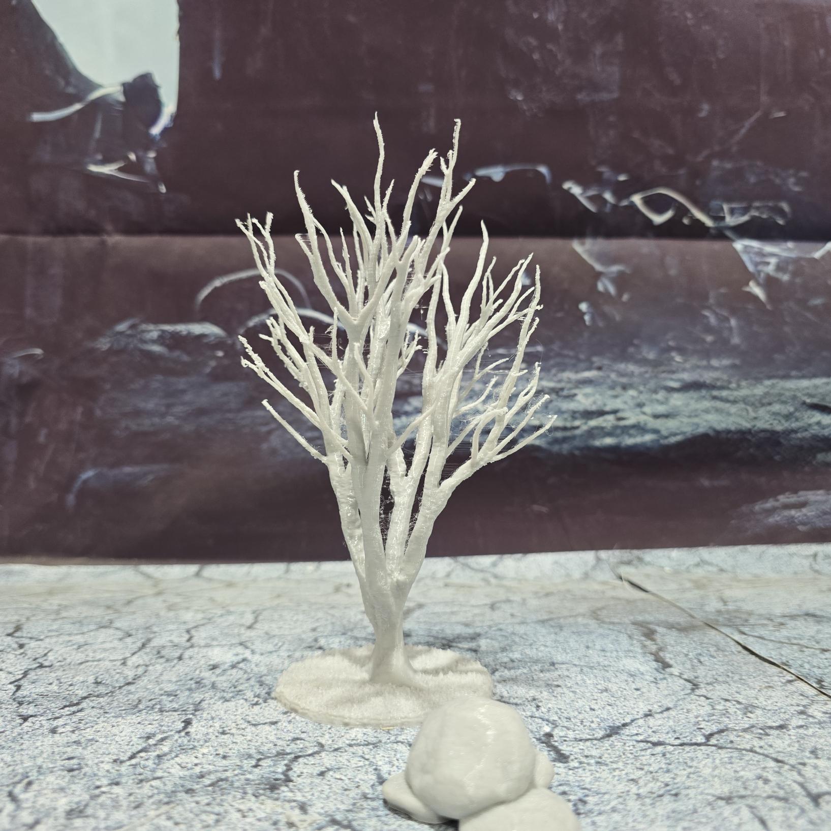 A set of 3 bare trees, each featuring intricate branches and a stable base. Perfect for creating desolate or haunted landscapes in tabletop RPGs and dioramas. Ideal for use in wintery or eerie settings.
