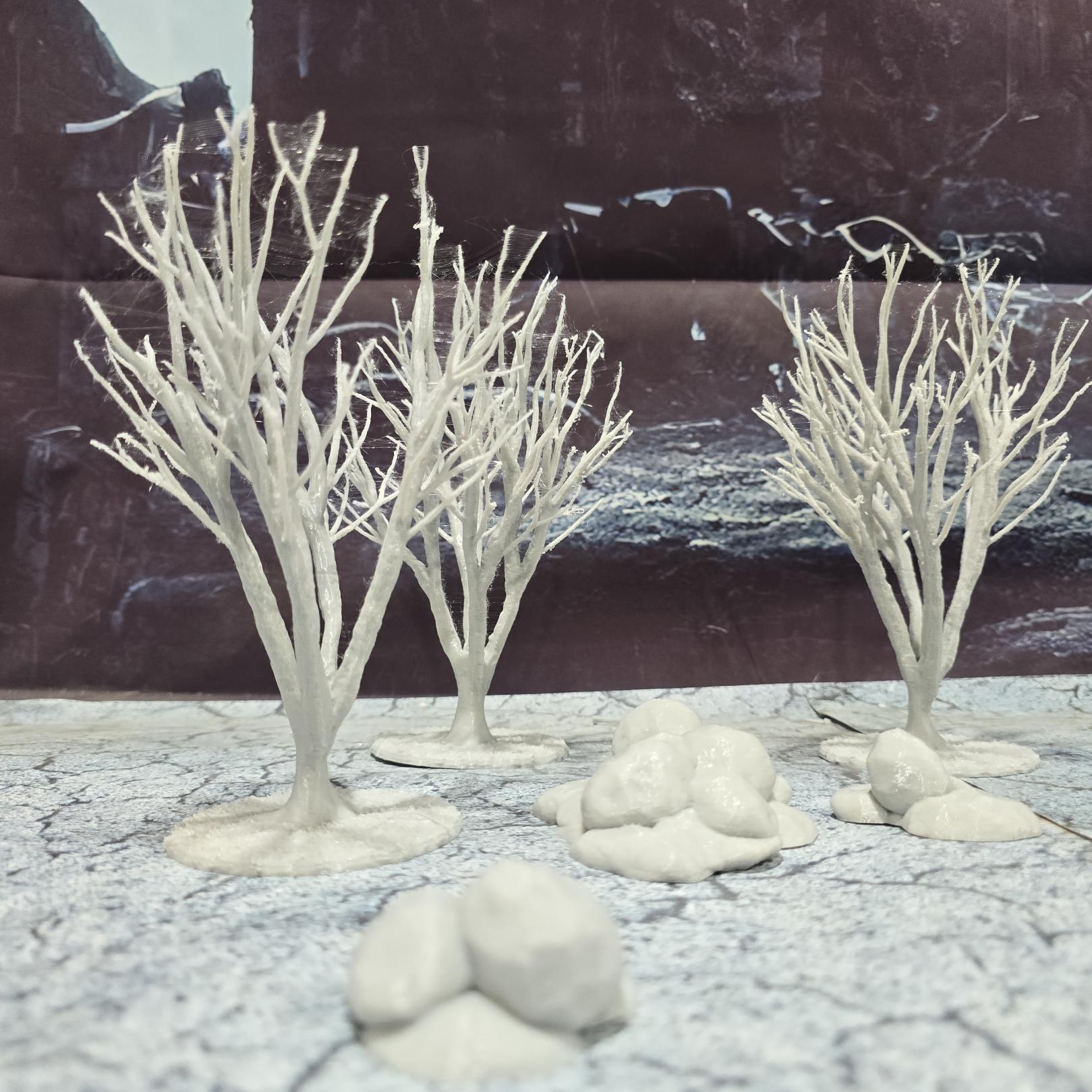 A set of 3 bare trees, each featuring intricate branches and a stable base. Perfect for creating desolate or haunted landscapes in tabletop RPGs and dioramas. Ideal for use in wintery or eerie settings.