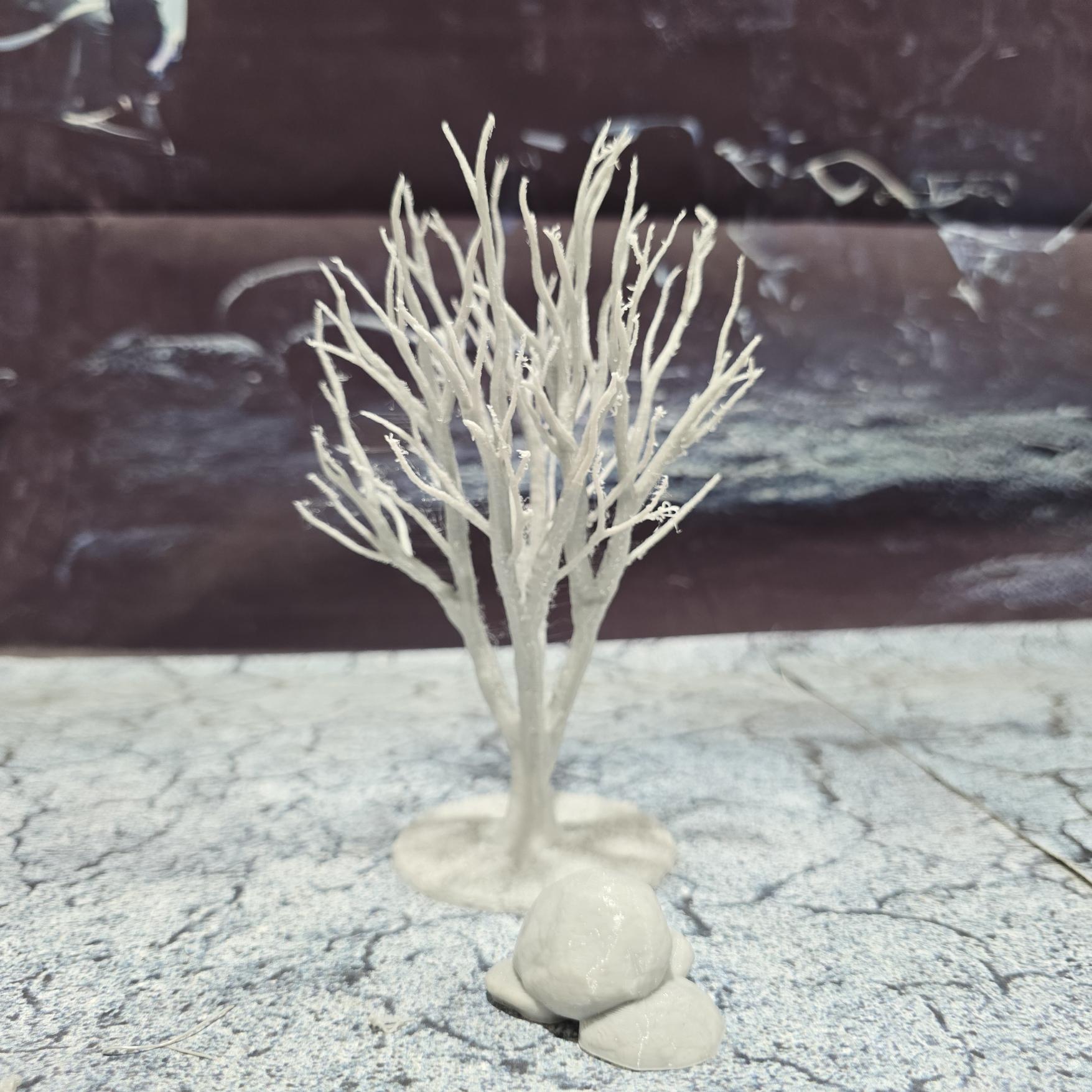A set of 3 bare trees, each featuring intricate branches and a stable base. Perfect for creating desolate or haunted landscapes in tabletop RPGs and dioramas. Ideal for use in wintery or eerie settings.