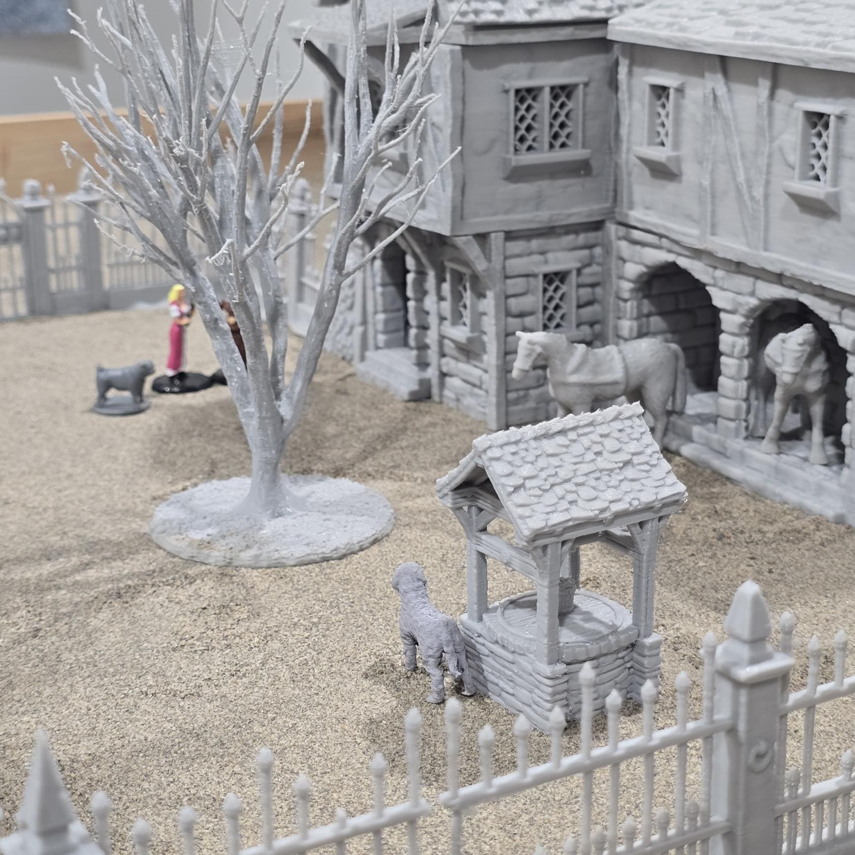 Exquisite 3D printed homestead model with detailed house, fencing, and barren trees, set against a rugged backdrop, perfect for tabletop games and dioramas.