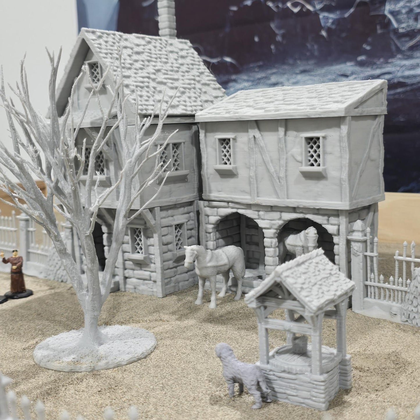 Exquisite 3D printed homestead model with detailed house, fencing, and barren trees, set against a rugged backdrop, perfect for tabletop games and dioramas.