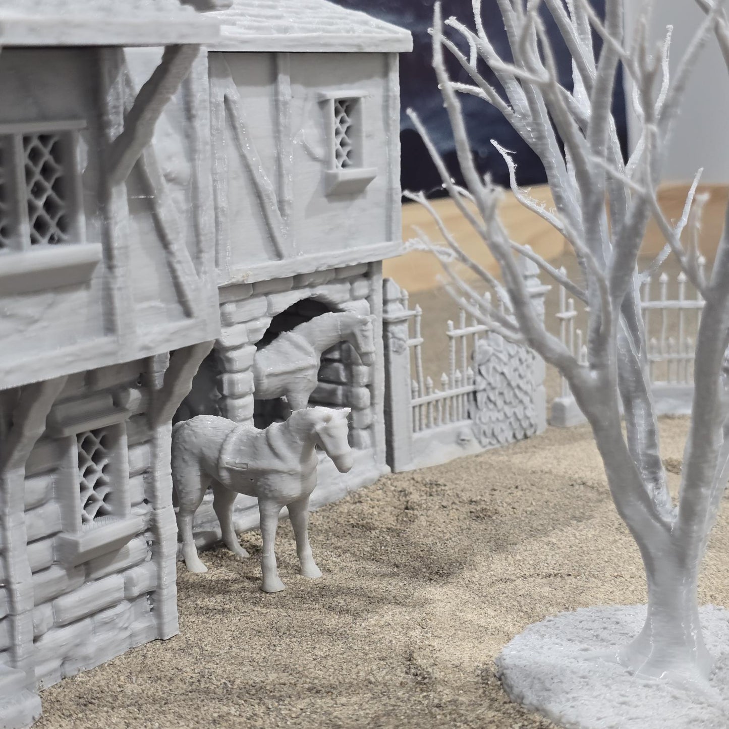 Exquisite 3D printed homestead model with detailed house, fencing, and barren trees, set against a rugged backdrop, perfect for tabletop games and dioramas.