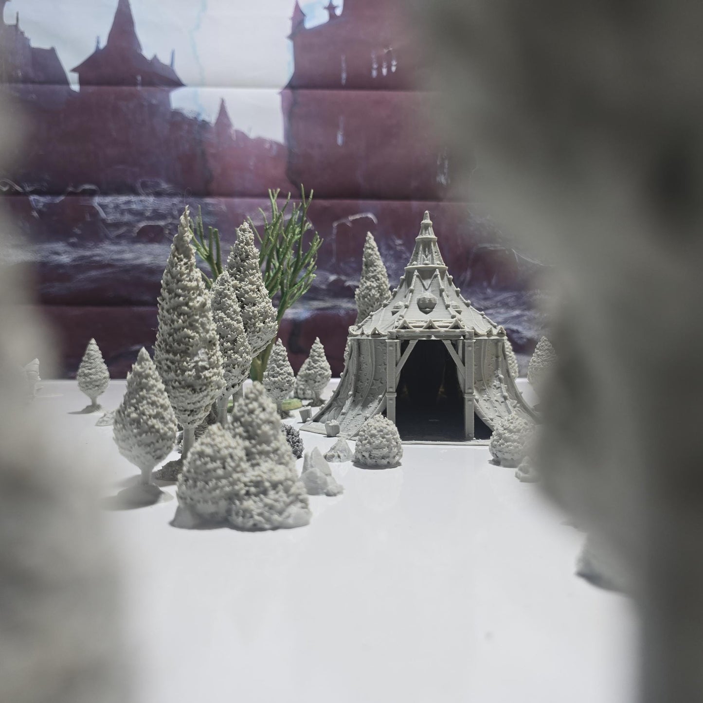 A star-patterned medieval fantasy tent glows with an otherworldly light, its interior revealing a robed fortune teller poised behind a crystal ball. The sweeping fabric walls and tall spire create an aura of mystery, perfect for a marketplace encounter, a festival scene, or a secret meeting in your next tabletop adventure.