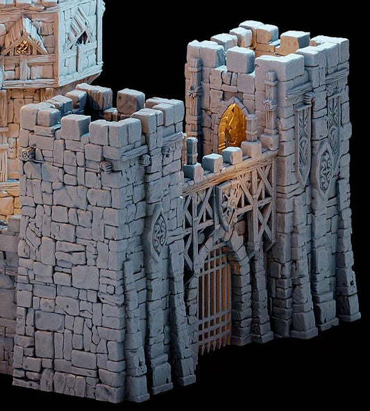The Main Gate of the Kingdom of Guardia rises with twin towers and a heavy portcullis, ready to repel invaders or welcome wary travelers. Miniatures can be placed on the battlements or at the gate below, setting the stage for sieges, defenses, and dramatic encounters.