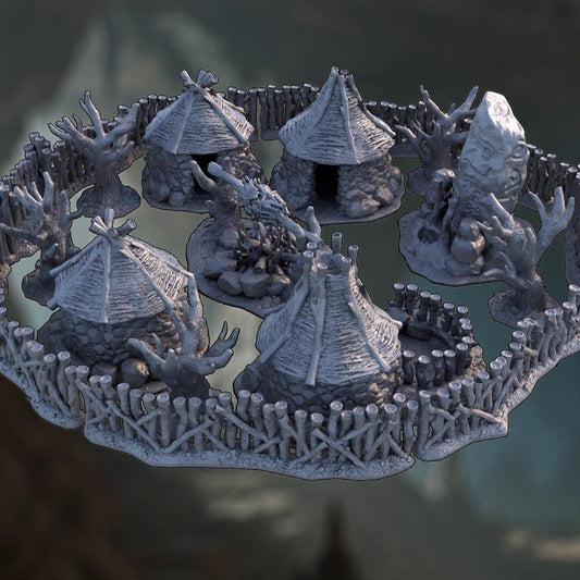 A 3D printed, unpainted gray PLA Cragborne Troll Camp fills a 28 mm tabletop footprint, built for a 1-inch grid. Four stone huts circle a massive fire pit while a rune-marked shrine and gnarled trees press against the inside of a rough timber wall. Every surface carries carved stone, stacked logs, and primitive detail suited for DnD / Pathfinder / wargaming encounters. The terrain arrives unpainted and ready for primer.